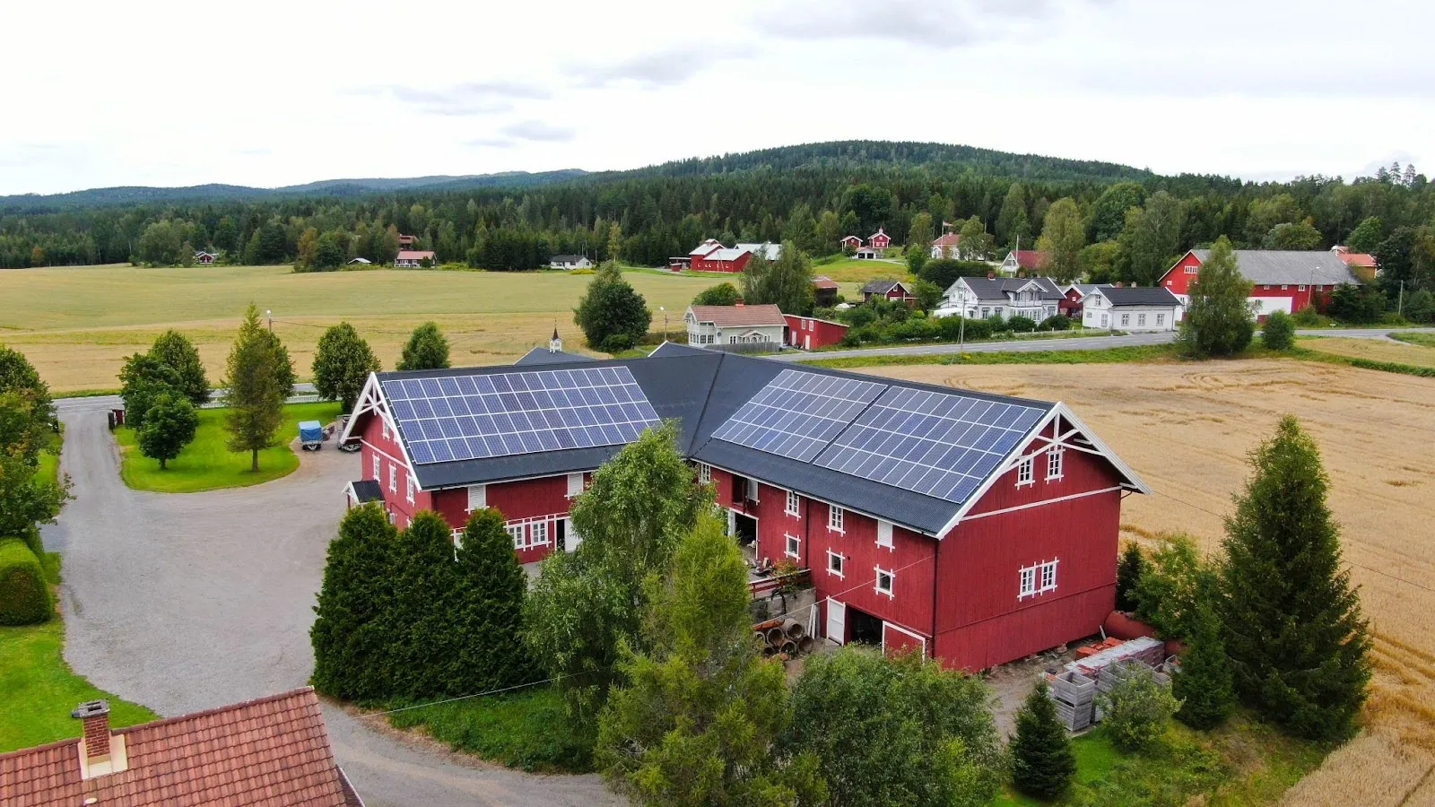 Låvetak med solcellepanel i et norsk jordbrukslandskap